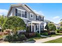 Inviting two-story home boasts of mature trees and lovely front yard landscaping at 7412 Soiree Way, Reunion, FL 34747