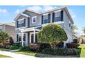 Beautiful two-story home showcases lush landscaping and a welcoming entrance at 7412 Soiree Way, Reunion, FL 34747