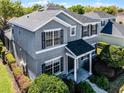 Stunning two-story home features a well-maintained lawn, mature landscaping, and modern architecture at 7412 Soiree Way, Reunion, FL 34747