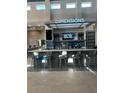 Lobby bar area featuring modern countertops, bar seating, and a television at 7740 Sandy Ridge Dr # 1, Kissimmee, FL 34744