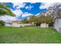 Spacious backyard with a lush lawn and mature trees, providing ample space for outdoor activities at 790 Park Ln, Kissimmee, FL 34741