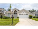 Inviting single-Gathering home with an attached two-car garage and well-maintained lawn at 8204 Fan Palm Way, Kissimmee, FL 34747