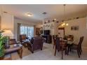 An open-concept living room and dining room with tile flooring and ample natural light at 8204 Fan Palm Way, Kissimmee, FL 34747