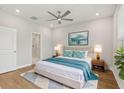 Bright bedroom with a ceiling fan, ensuite bathroom, and hardwood flooring at 117 E Concord St # 8, Orlando, FL 32801