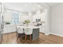 Contemporary kitchen with a gray island, white cabinets, stainless steel appliances, and a view to the window at 117 E Concord St # 8, Orlando, FL 32801