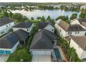 Beautiful aerial view of the home with a private pool and stunning lake in the background at 13041 Gabor Ave, Orlando, FL 32827