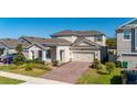 Charming two-story home with well-manicured landscaping and a brick driveway at 14321 Wabasso Loop, Winter Garden, FL 34787