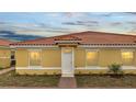 Exterior elevation of a home with a red-tile roof and manicured front yard at 1783 Coriander Dr, Kissimmee, FL 34759