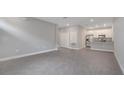 Spacious living area with modern gray tile flooring seamlessly transitioning to a sleek kitchen at 1785 Coriander Dr, Kissimmee, FL 34759