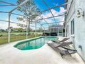 Screened-in pool with lounge chairs offering a perfect spot for outdoor relaxation and leisure at 2105 Mallory Cir, Haines City, FL 33844