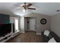 Comfortable living room featuring wood floors, ceiling fan, and stylish decor at 214 Kay St, Auburndale, FL 33823