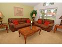 Comfortable living room with plush sofas, warm lighting, and a picturesque view at 215 Cordova Ave, Davenport, FL 33897