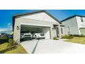 Spacious two-car garage with modern doors offers ample parking and storage for your vehicles and belongings at 2166 Derwent Dr, Davenport, FL 33896