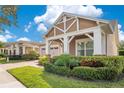Beautiful single-Gathering home featuring manicured landscaping and a brick paved driveway at 2460 Promenade Dr, St Cloud, FL 34772