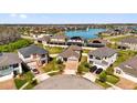 Aerial view of neighborhood homes surrounding a community lake and fountain, showcasing a tranquil residential setting at 2468 Varenna Loop, Kissimmee, FL 34741