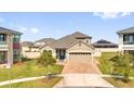 Inviting single-Gathering home with a manicured front yard and brick driveway, set in a Gathering-friendly neighborhood at 2468 Varenna Loop, Kissimmee, FL 34741