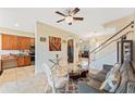 Bright and open living room showcases tile floors, natural light, seamlessly connecting to the kitchen and staircase at 2814 Plymouth Pl, Kissimmee, FL 34741