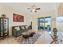 Cozy living room featuring tile floors, a ceiling fan, comfortable seating and sliding glass doors to the outdoor patio at 2814 Plymouth Pl, Kissimmee, FL 34741