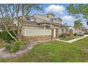 Attractive exterior of a townhouse, featuring brick accents and a well-manicured lawn, creating a cozy and inviting atmosphere at 3203 Rio Grande Trl, Kissimmee, FL 34741