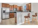 Kitchen with stainless steel appliances, a breakfast bar, and lots of wooden cabinet space at 3471 Julius Estates Blvd, Winter Haven, FL 33881
