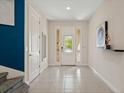 Welcoming foyer with tile flooring, white walls, and glass panel front door bringing in lots of natural light at 385 Southfield St, Kissimmee, FL 34747