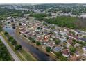 Residential neighborhood with houses along a creek and the subject property marked with a house icon at 502 Woodland Creek Blvd, Kissimmee, FL 34744
