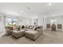 Spacious living room open to the dining area, featuring comfortable seating and plenty of natural light at 541 Jerry Ln, Haines City, FL 33844
