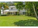 Two-story home surrounded by lush landscaping and a well-manicured lawn creating a picturesque curb appeal at 6100 Alligator Lake W Shr, St Cloud, FL 34771