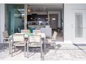 Outdoor patio featuring dining set looking into home with tile flooring and lots of natural light at 8936 Sydney Ave, Kissimmee, FL 34747