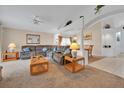 Spacious living room featuring neutral tones, carpet flooring, and an open layout to the dining area at 1010 Prey Ct, Kissimmee, FL 34746