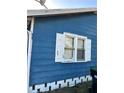 Exterior view of a blue home with white trim around windows, with a visible trash can at 1011 26Th Street, Orlando, FL 32805