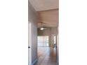 Spacious hallway with tile flooring leading to the living areas, and natural light through sliding glass doors at 1017 Winding Water Way, Clermont, FL 34714