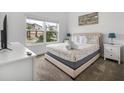 Comfortable bedroom features natural light and neutral decor for a relaxing retreat at 1034 Splash Shot Pl, Davenport, FL 33896