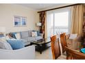 Living room with modern furniture, balcony access, and a view of the ocean at 13427 Blue Heron Beach Dr # 1607, Orlando, FL 32821
