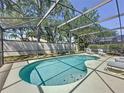 Inviting screened-in pool with clear water and ample space for lounging poolside at 1361 Rebecca Dr, Haines City, FL 33844