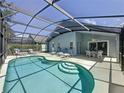 Beautiful screened-in pool area with patio seating, perfect for outdoor entertaining at 1361 Rebecca Dr, Haines City, FL 33844