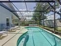 Relaxing poolside view with comfortable lounge chairs and a serene backyard setting at 1361 Rebecca Dr, Haines City, FL 33844