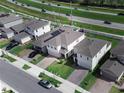 Community aerial view displaying multiple homes, green spaces, and vehicle traffic at 1371 Red Blossom Ln, Kissimmee, FL 34746