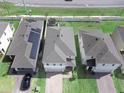 Bird's eye view of homes, showing rooflines, yards, and nearby highway at 1371 Red Blossom Ln, Kissimmee, FL 34746