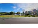 Scenic park view featuring green spaces, mature trees, and a lake under a blue sky at 151 E Washington St # 327, Orlando, FL 32801