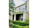 Charming two-story home with well-manicured lawn and a welcoming front porch at 15687 Kinnow Mandarin Ln, Winter Garden, FL 34787