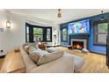 Cozy living room featuring a modern fireplace, bay window and hardwood flooring at 204 E Harvard St, Orlando, FL 32804