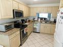 Well-equipped kitchen with stainless steel appliances and granite countertops at 2160 Addison Ave, Clermont, FL 34711