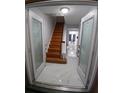 Welcoming entryway features marble flooring, a wooden staircase, and decorative glass doors at 2211 New Jersey Rd, Lakeland, FL 33803