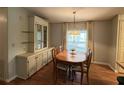 Traditional dining room with wood table, chandelier, built-in hutch, and light-filled window at 222 Palmer Park Ln, Davenport, FL 33897