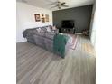 Spacious living room features wood-look flooring, ceiling fan, and a decorative accent wall at 2802 Glendive Dr, Kissimmee, FL 34758