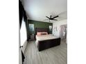 Bright main bedroom boasts an accent wall, ceiling fan, and luxury vinyl plank flooring at 2802 Glendive Dr, Kissimmee, FL 34758