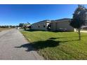 Large backyard, perfect for entertaining, with green grass, picnic table and grill at 3100 Rocky River Rd, Kissimmee, FL 34746