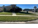 Well-maintained front lawn of the home with a view of the street at 3100 Rocky River Rd, Kissimmee, FL 34746