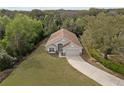 Aerial view of the home showcasing lush surroundings and a well-manicured lawn at 3193 Verbena Ct, Deltona, FL 32725